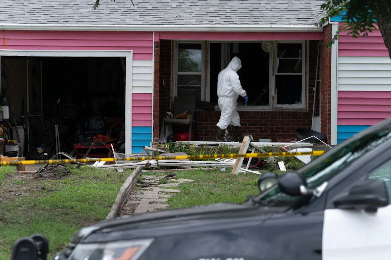 Topeka police on July 30 enter Topeka's "Mott House" at 1204 SW Orleans, where they were investigating the death earlier that day of a man suspected of committing a homicide in Oklahoma City, Oklahoma.