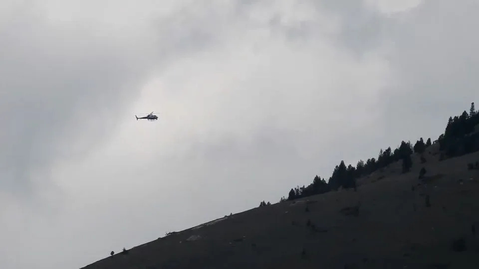 A helicopter circles Garrity Mountain on Saturday in the manhunt for Michael Paul Brown, who is suspected of killing four people at The Owl Bar in Anaconda, Montana. - Dan Haffey