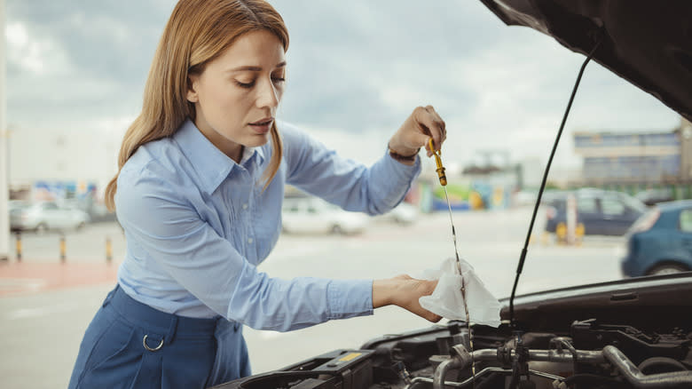 Woman checking oil