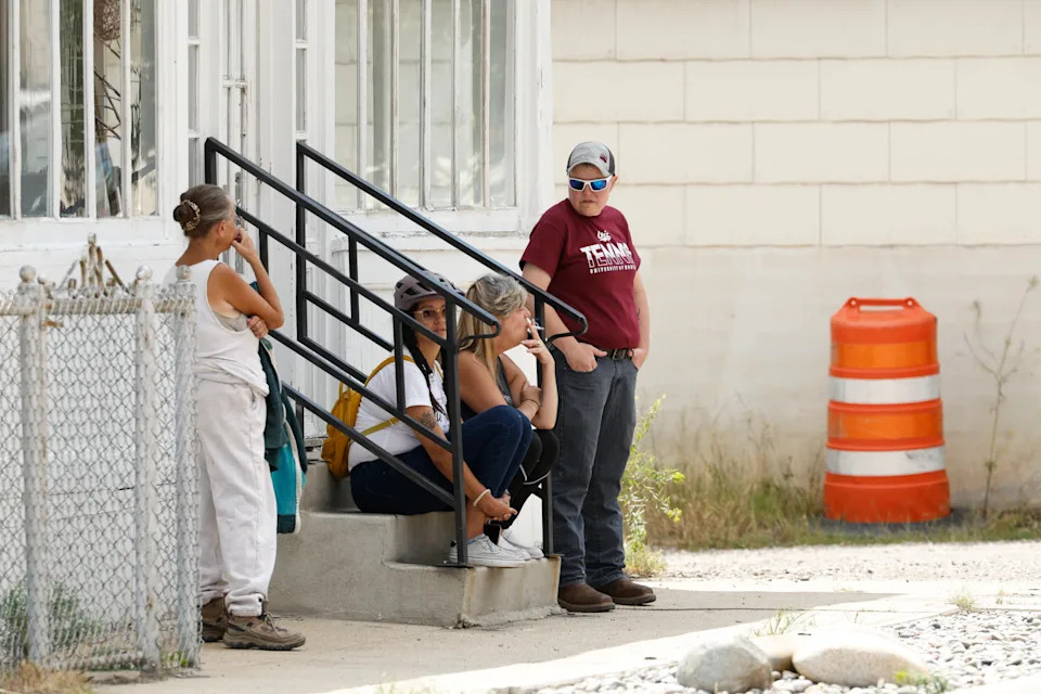 People are seen in the town of Anaconda, Mont., following a reported shooting, Friday, Aug. 1, 2025. (Joseph Scheller/The Montana Standard via AP)