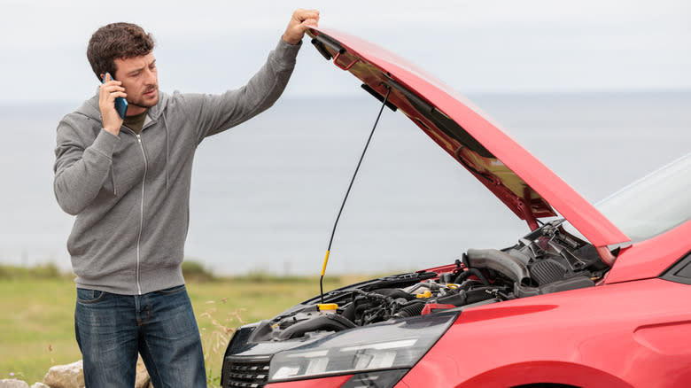 A man broke down with car hood open