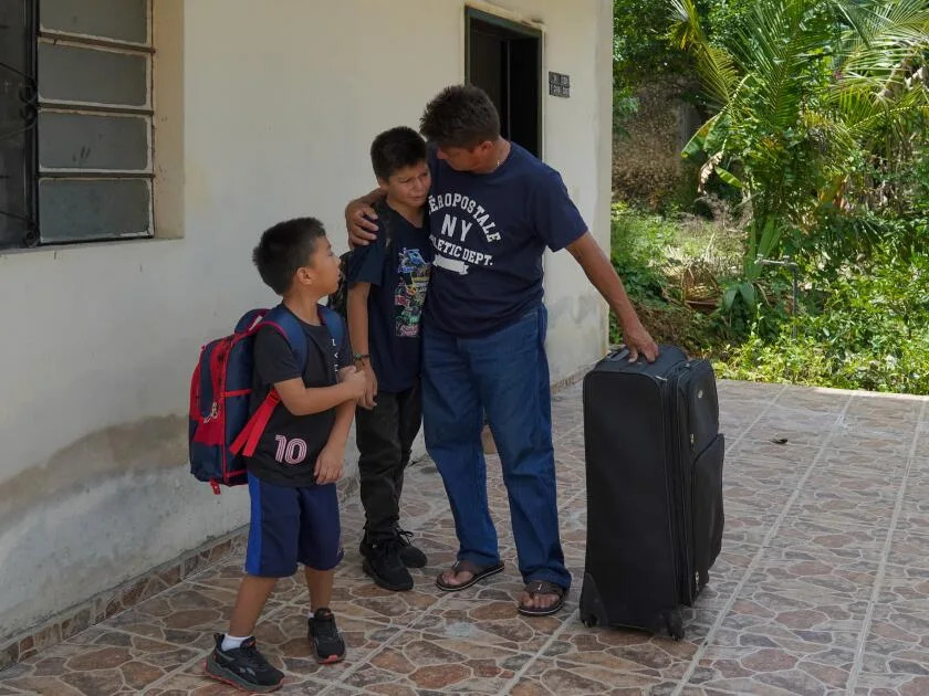 Jesus Cruz comforts his son Angel