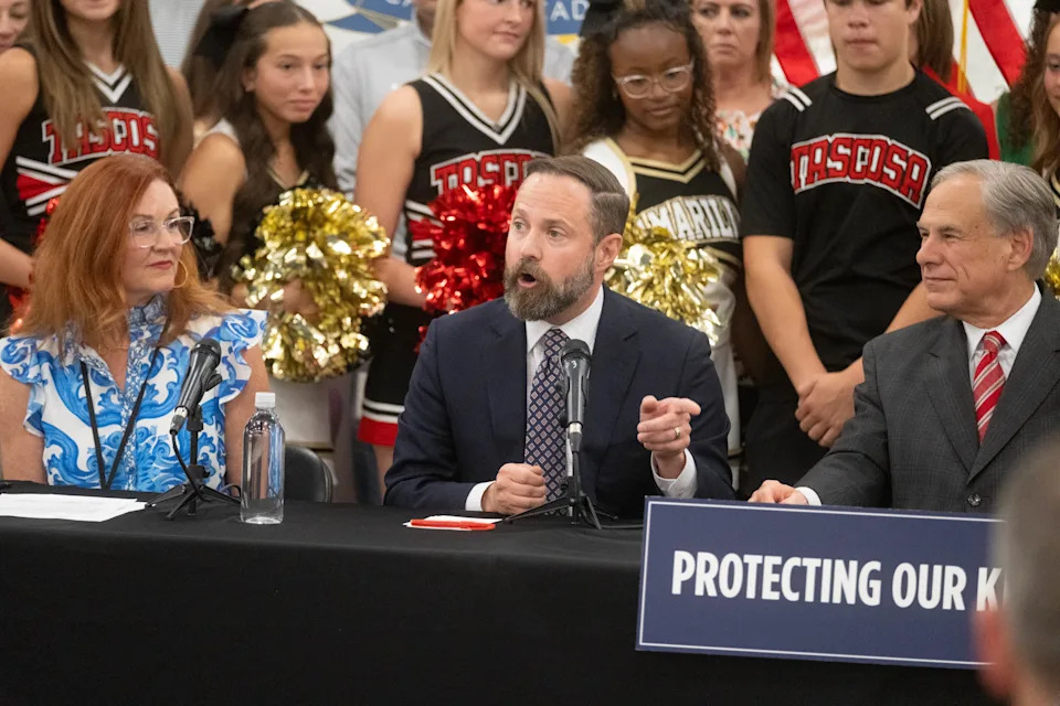 Texas House Speaker Dustin Burrows speaks as Amarillo ISD Superintendent Dr. Deidre Parish and Gov. Greg Abbott look on during a student-focused legislative event Aug. 1, 2025, at AmTech Career Academy in Amarillo.
