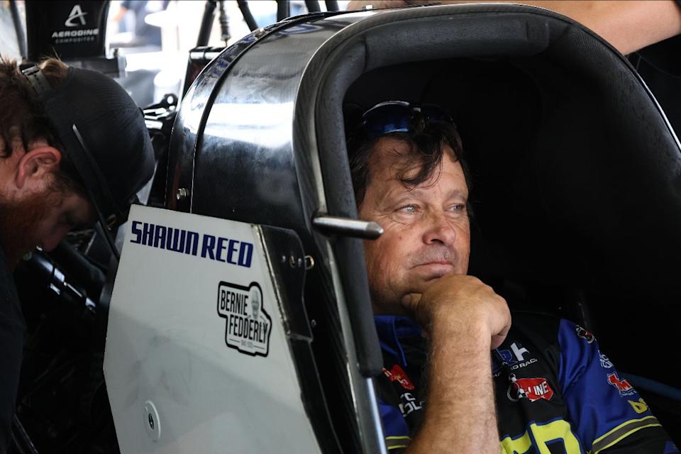 driver preparing in a race car cockpit