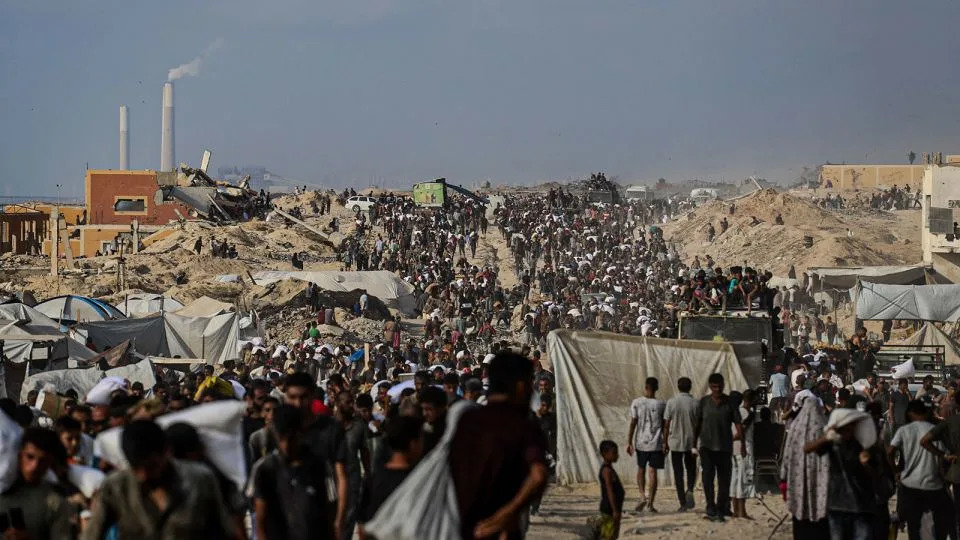 Palestinians gather near Gaza's Zikim crossing, as flour and other essential supplies were distributed on Friday, August 8, 2025. - Abaca Press/SIPAPRE/Sipa USA via AP