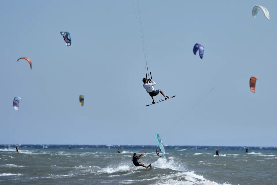 Many kiteboarders sail together.