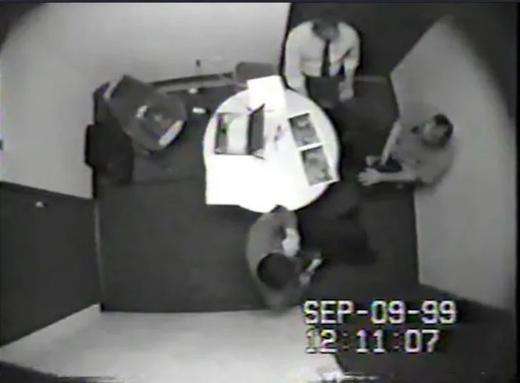 Michael Scott, seated right, is pictured in 1999 being questioned by Austin Police. His 20-hour interrogation took place over the course of four days, during which Scott confessed to taking part in the yogurt shop murders. Days later, Robert Springsteen also confessed under questioning. Despite both men later claiming their confessions were coerced, they would eventually be convicted. / Credit: Austin Police Department