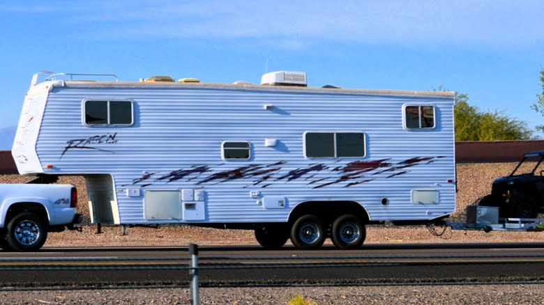 pickup double tows a camper and another trailer