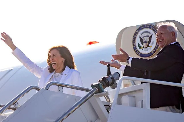 Emily Elconin/Bloomberg via Getty Kamala Harris and Tim Walz disembark Air Force Two in Detroit, Michigan, on Aug. 7, 2024.