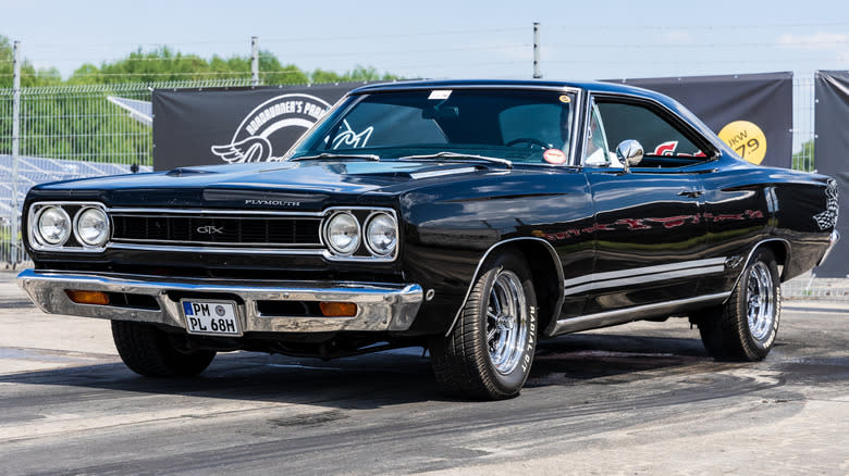 A Plymouth Roadrunner in black on pavement.