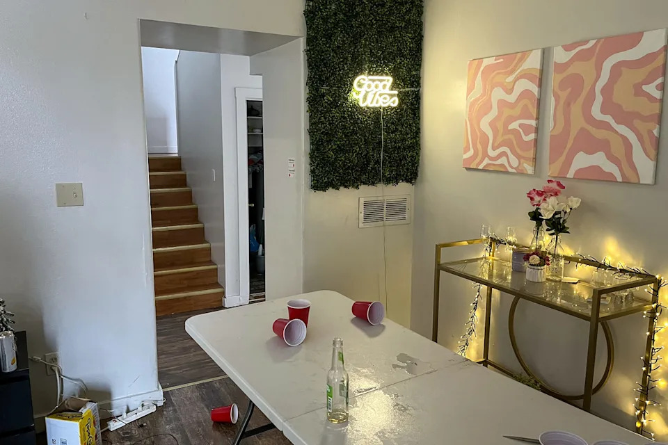 Living room with black couch, party items and backpack on floor. (Moscow Police Department)