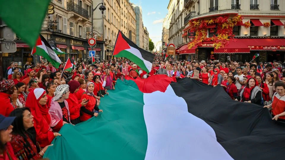 A crowd of protesters gather around a large Palestinian flag during the Red Line for Gaza demonstration in Paris, on July 8. - Henrique Campos/Hans Lucas/AFP/Getty Images/File