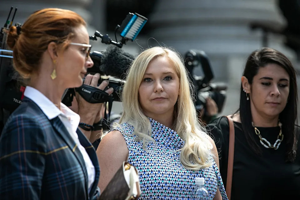 Virginia Giuffre, an alleged victim of Jeffrey Epstein, center, exits from federal court in New York on Aug. 27, 2019. (Jeenah Moon / Bloomberg via Getty Images file)