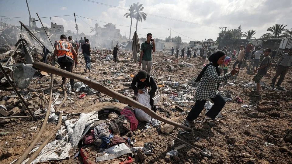 A view of the destroyed camp, which houses displaced Palestinians, after Israeli army targeted the camp as Palestinians gather to inspect the site in Deir Al Balah, Gaza on Thursday. - Ali Jadallah/Anadolu/Getty Images