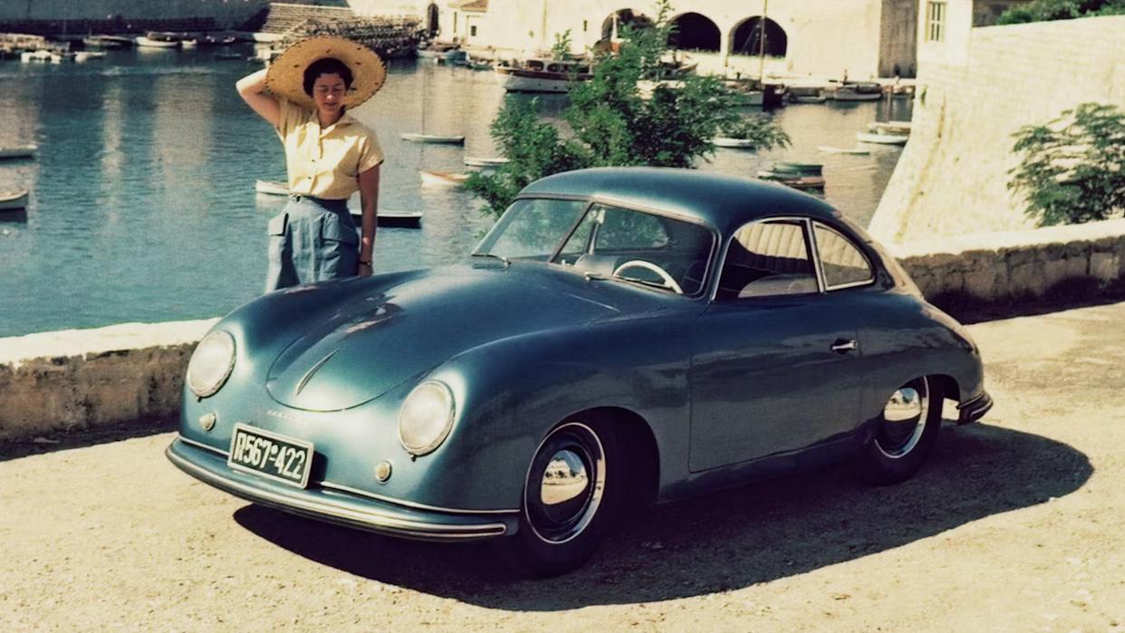 Blue Porsche 356 Coupe Pre-A Parked Next To Woman Front 3/4 View
