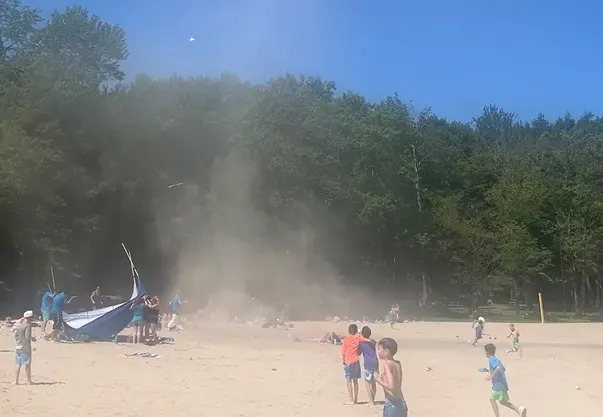 Dust devil wreaks havoc on New York beach as children run screaming for cover