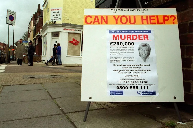 Sign on the street asking for information on a murder case, offering a £250,000 reward, with contact details for the Metropolitan Police