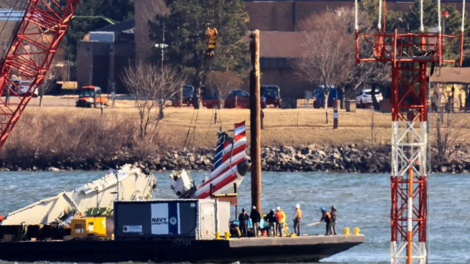 A crane retrieves part of the wreckage from American Airlines flight 5342, which was operated by PSA Airlines, on February 4, 2025. - Eduardo Munoz/Reuters