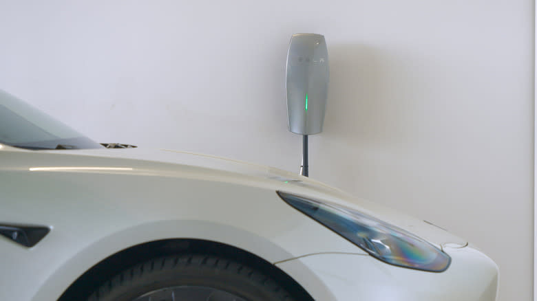 A Tesla charging inside a garage