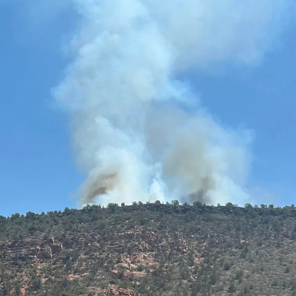 Firefighters from the U.S. Forest Service and Sedona Fire District were working together to contain the Woods Fire, located about 2 miles east of the Village of Oak Creek atop Horse Mesa, roughly 6 miles southeast of Sedona. The fire was seen in an Aug. 13, 2025 photo.