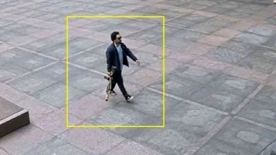 In an image obtained by CNN, Shane Devon Tamura is seen outside the 345 Park Avenue office building carrying a rifle. - Obtained by CNN