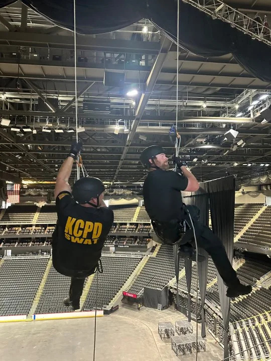 SWAT officers hanging from ropes during training