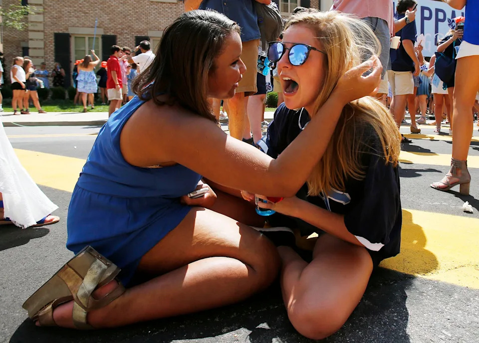 Logan Doctson, left, and Mary Neill Stark share a moment on the ground after Doctson hugged Stark and the girls fell to the ground in front of the Kappa Kappa Gamma house during UA's annual Bid Day on Saturday, Aug. 19, 2017. Of the 2,589 young women that participated in UA's Panhellenic Fall recruitment, 2,338 received bids for one of the 16 sororities during UA's annual Bid Day in Tuscaloosa.  [Staff Photo/Erin Nelson]