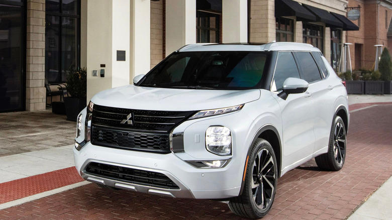 a white suv parked on a high-end street