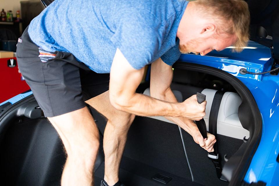 adjusting the seatbelt in a vehicles trunk area