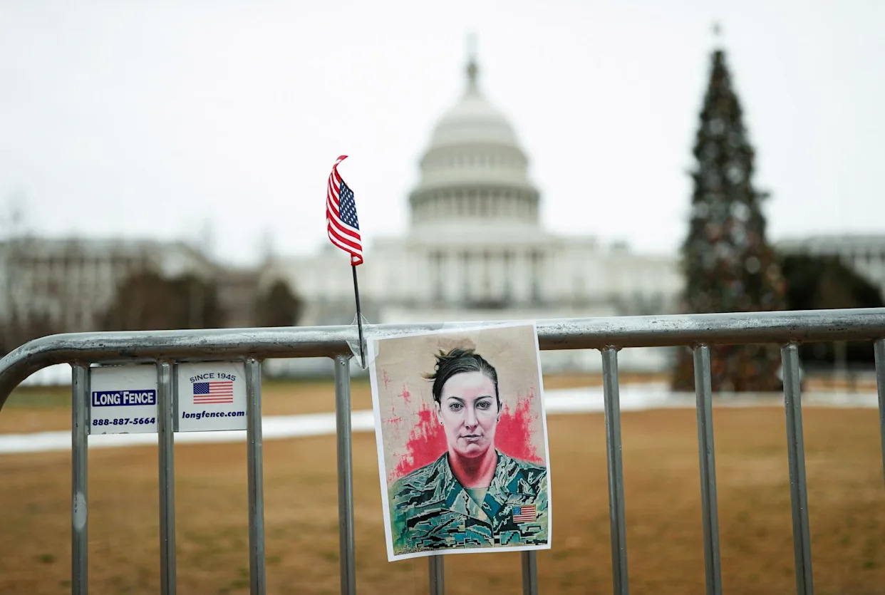<span>A portrait of Ashli Babbitt is affixed to a fence near the capitol in Washington DC on 6 January 2022.</span><span>Photograph: Tom Brenner/Reuters</span>