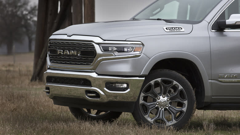 A silver 2019 Ram 1500 Limited parked in grass.