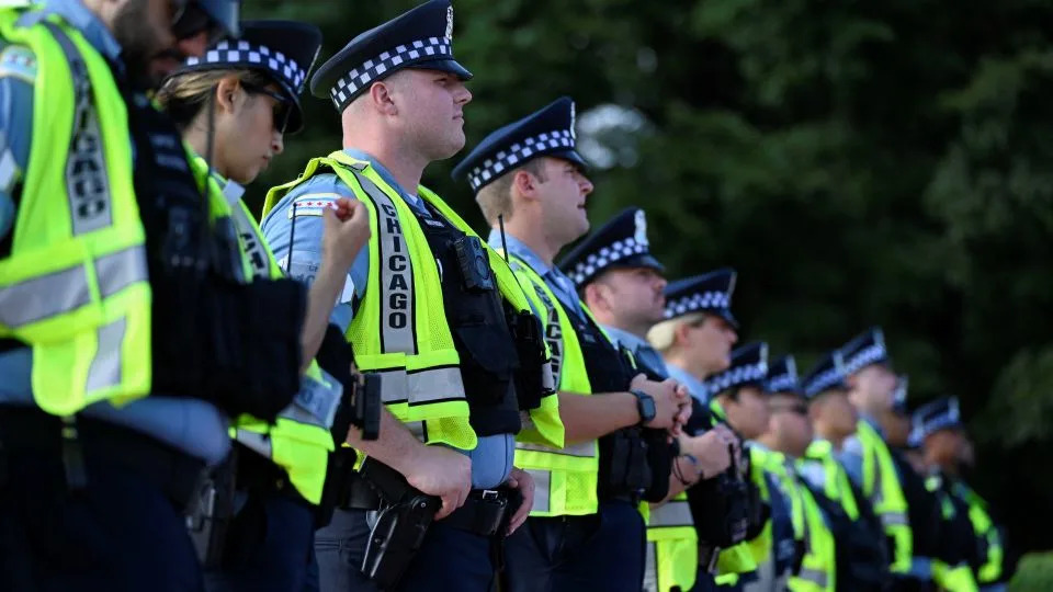 Policemen stand guard during a demonstration calling for justice for Sonya Massey in Chicago on August 17, 2024. - Vincent Alban/Reuters
