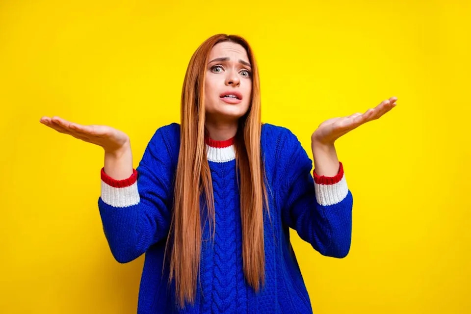 Woman gesturing that she's confused.
