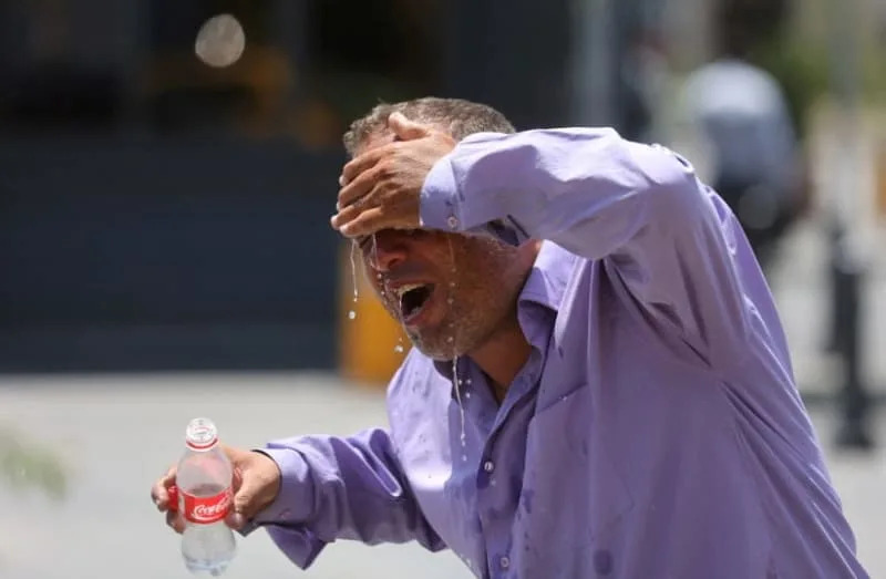 An Iranian taxi driver splashes water on himself to cool down during the heat surge in Tehran, Iran July 21, 2024. (credit: MAJID ASGARIPOUR/WANA (WEST ASIA NEWS AGENCY) VIA REUTERS)
