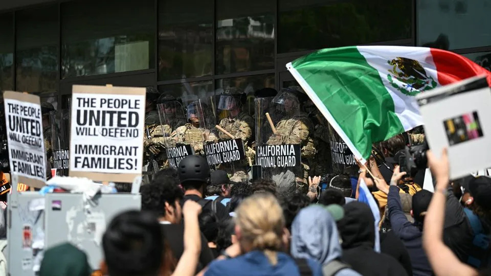 Demonstrators face California National Guard members standing guard outside the Federal Building during a protest in response to federal immigration operations in Los Angeles on June 9. - Ronaldo Schemidt/AFP/Getty Images