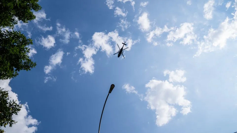 A police helicopter flies over the Jame Masjid Mosque in the Bronx. - Timothy Fadek for CNN