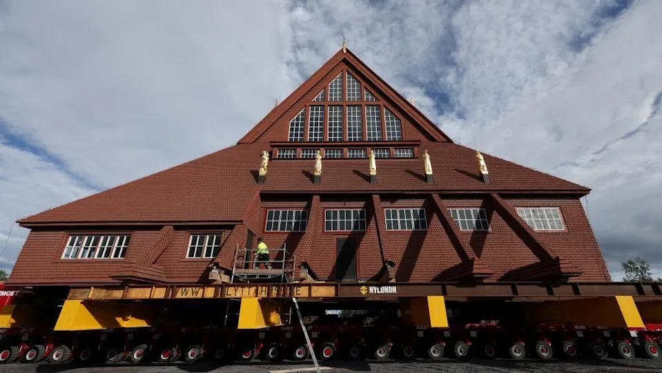 Kiruna's historic wooden church sits on a wheeled transportation unit before being moved to a new site in Kiruna, Sweden 