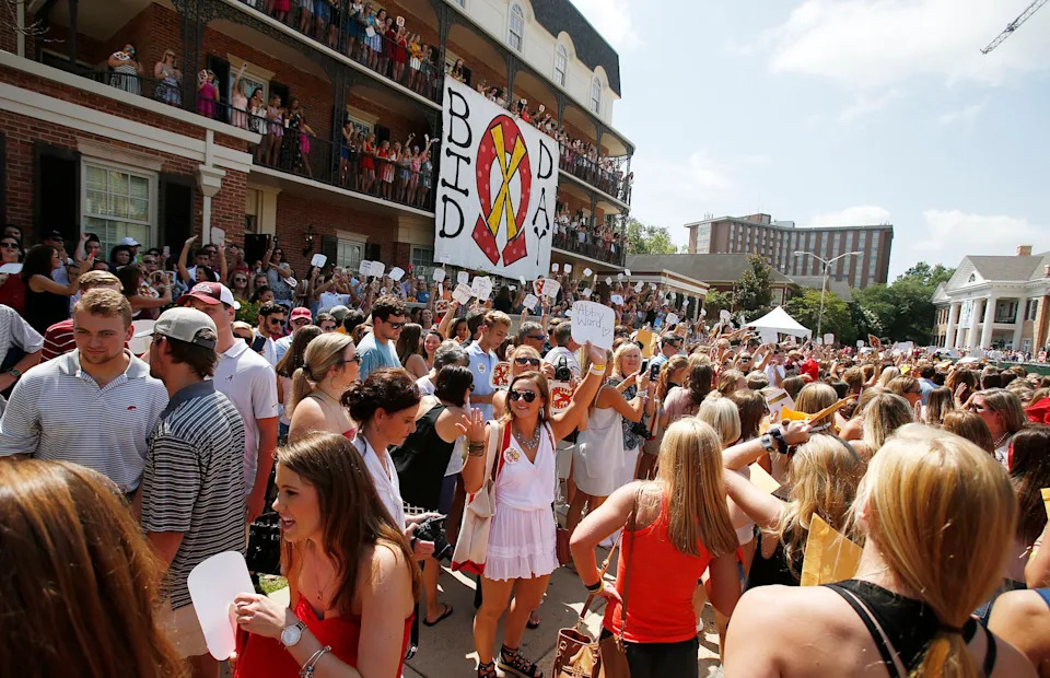 Current members of Chi Omega hold up signs for their Bid Day Little sisters in front of the Chi Omega house during the University of Alabama's annual Panhellenic Fall recruitment Bid Day on Saturday, Aug. 19, 2017. Of the 2,589 young women who participated in recruitment, 2,338 received bids for one of the 16 sororities on campus Saturday. [Staff Photo/Erin Nelson]
