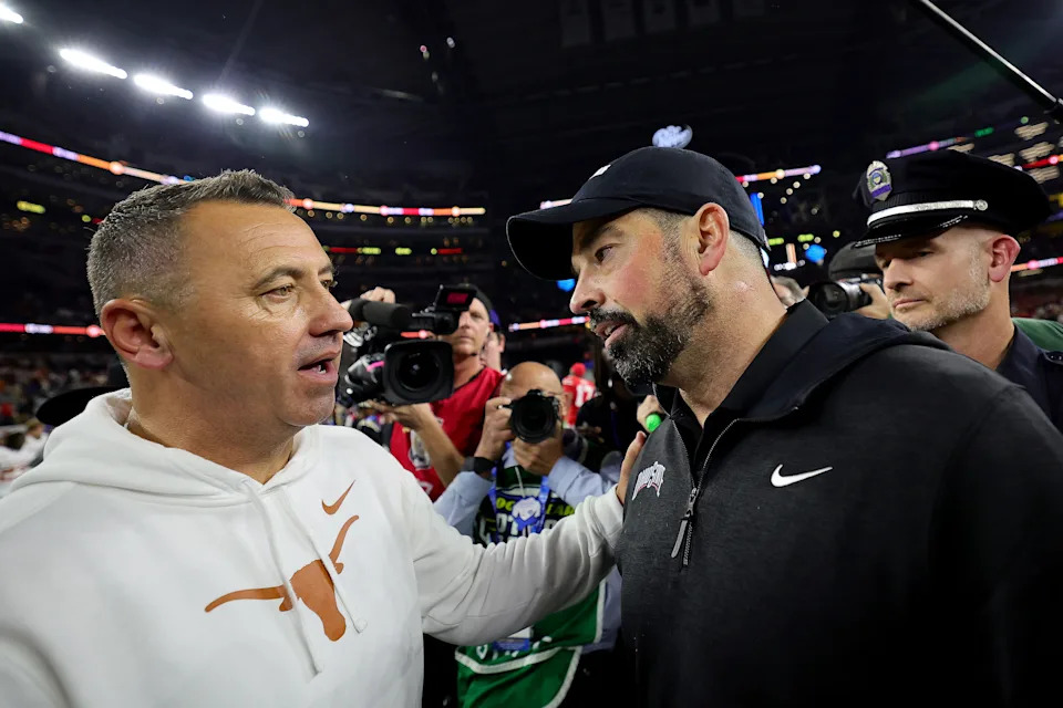 ARLINGTON, TEXAS - JANUARY 10: Head coach Steve Sarkisian of the Texas Longhorns and head coach Ryan Day of the Ohio State Buckeyes meet after Ohio State beat Texas 28-14 to win the Goodyear Cotton Bowl at AT&T Stadium on January 10, 2025 in Arlington, Texas. (Photo by Alex Slitz/Getty Images)