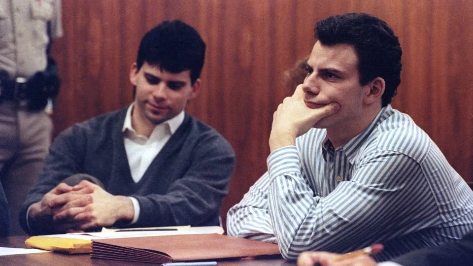 Erik Menendez, right, and his brother, Lyle, listen to court proceedings in 1991. - Lee Celano/Reuters