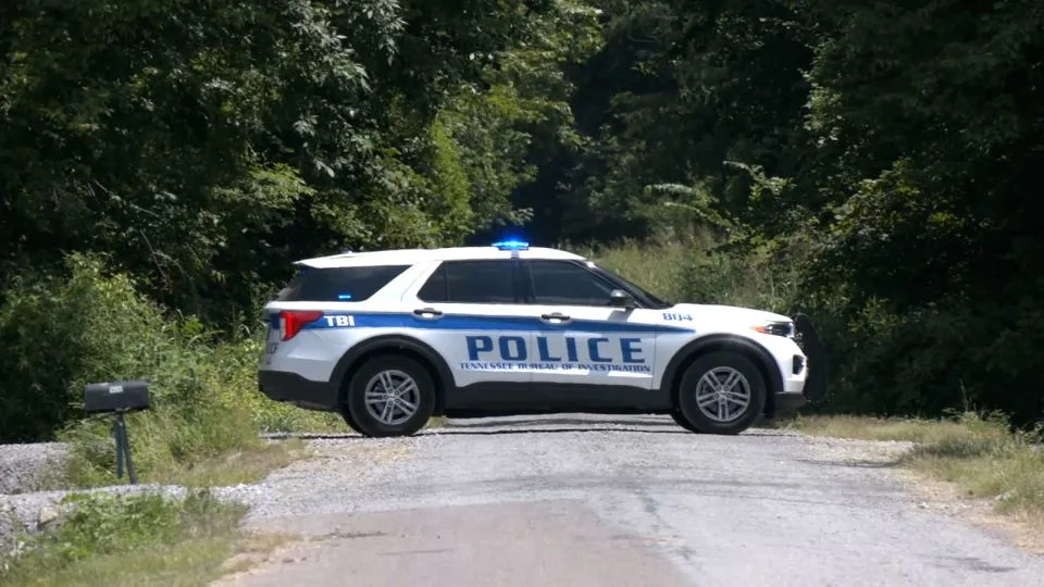 A police vehicle parks in Lake County, Tennessee, where the bodies were found - WHBQ