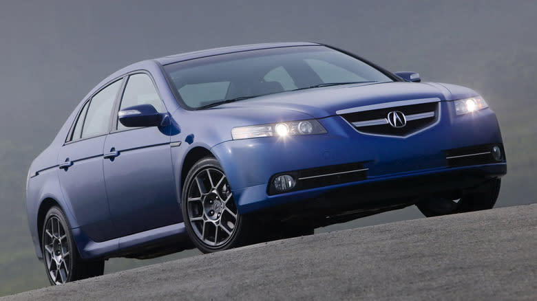 A blue Acura TL Type S parked on asphalt
