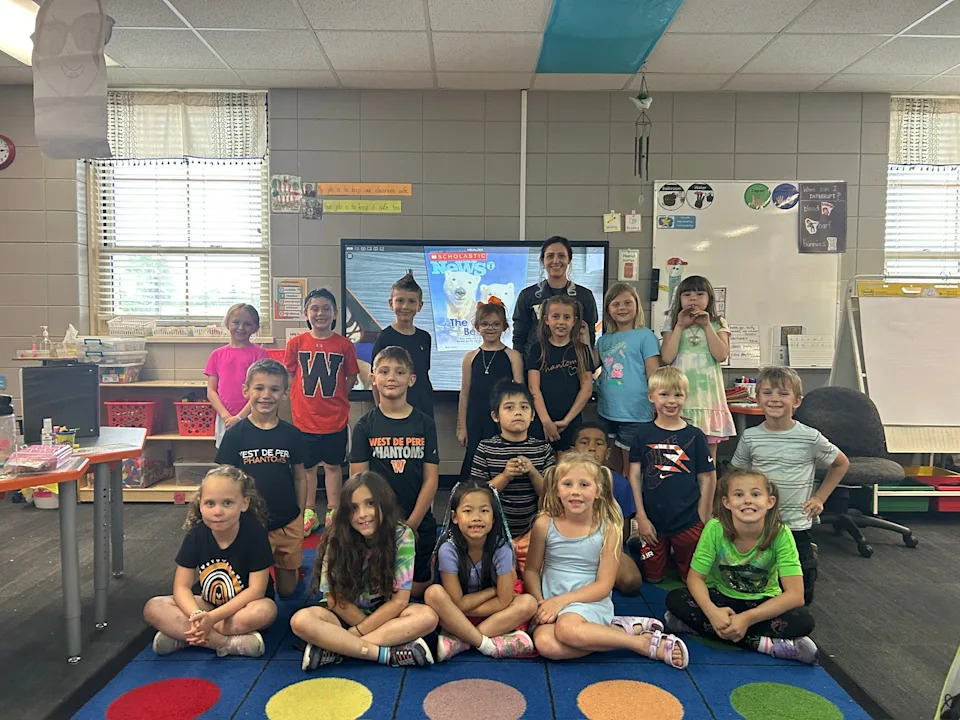 Westwood Elementary School teacher Jennifer Klika and her first-grade class pose for a picture at the De Pere school.