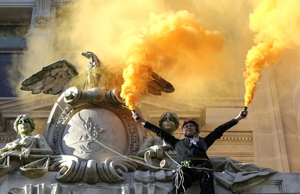 Protester lights flares at an environmental demonstration