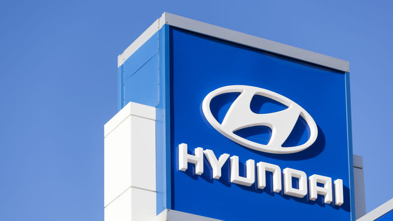 Halifax, Nova Scotia, Canada - December 11, 2011: Hyundai sign and logo above car dealership lot over building and showroom with clear, blue sky in background. Hyundai Motor Company was founded in 1967 and is known for producing the Hyundai Sonata, the Tuscani/Tiburon, the Sante Fe, the Tuscon, and the flagship Genesis Coupe and Sedan.