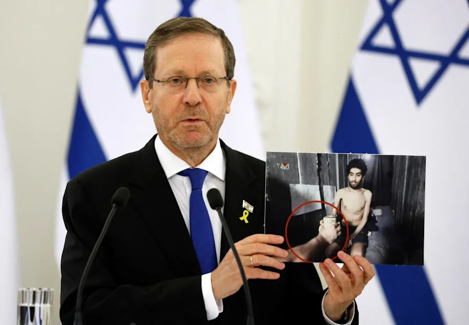 Israeli President Isaac Herzog holds a photo of David looking weak and malnourished, during a press conference with Lithuania’s President (not in picture) at the presidential palace in Vilnius, Lithuania on August 4, 2025. (Photo by PETRAS MALUKAS/AFP via Getty Images)