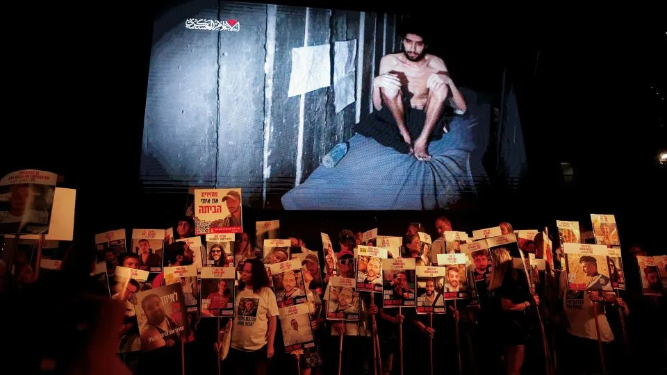 A video released by Hamas of hostage Evyatar David is displayed at a protest in Tel Aviv, Israel on Saturday. - Ammar Awad/Reuters