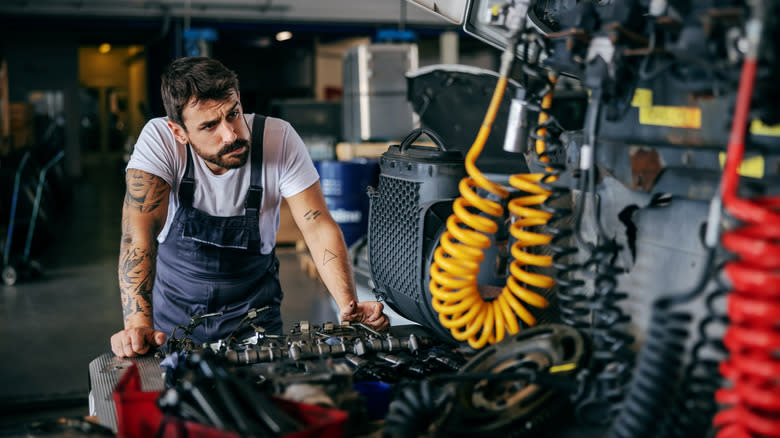Mechanic checking on the truck diesel engine