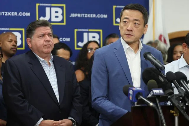 Talia Sprague/Bloomberg via Getty Illinois Gov. J.B. Prtizker (left) with Texas State Rep. Gene Wu in Carol Stream, Ill. on Aug. 3