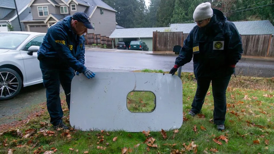 National Transportation Safety Board officials retrieve the missing door plug from Alaska Airlines flight 1282, the Boeing 737 MAX 9 that experienced a rapid decompression over Portland, Oregon. - NTSB